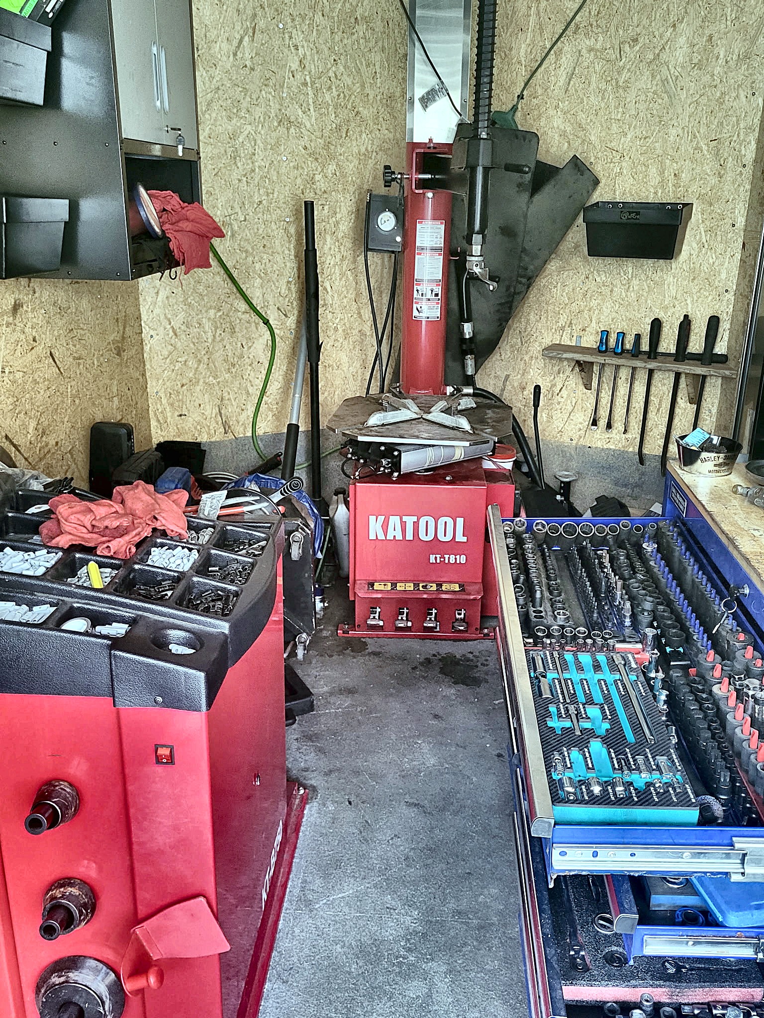 Inside the C&C mobile shop trailer — tire machine and tool chests, ready to roll